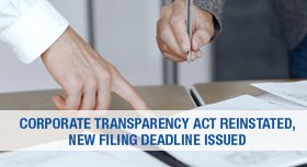 Hands reviewing a document with a banner about the Corporate Transparency Act.