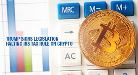 Bitcoin and calculator with a banner about halting an IRS crypto tax rule.