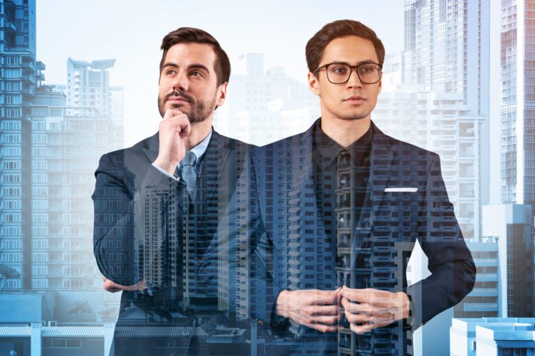 Double exposure of two businessmen thinking with a city skyline background.